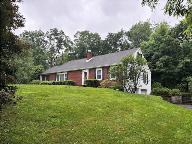 15 Orchard Rd, Poughkeepsie, NY 12603 - single story home with a chimney, a front yard, brick siding, and an attached garage