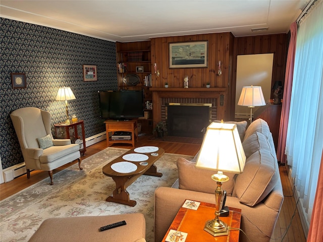 15 Orchard Rd, Poughkeepsie, NY 12603 - living area with wood finished floors, a brick fireplace, ornamental molding, and wallpapered walls