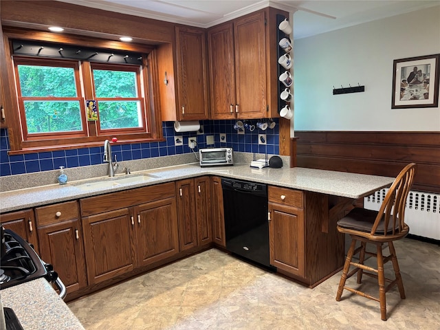 15 Orchard Rd, Poughkeepsie, NY 12603 - kitchen with black dishwasher, radiator heating unit, a sink, a peninsula, and a breakfast bar area