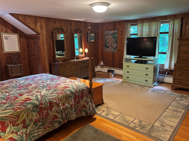 15 Orchard Rd, Poughkeepsie, NY 12603 - bedroom featuring a baseboard heating unit, wood walls, and wood finished floors