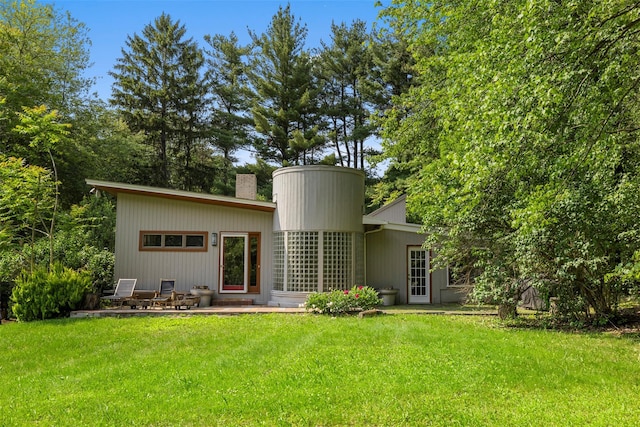 15 Relyea Ter, Wappingers Falls, NY 12590 - rear view of property featuring a chimney, a yard, and a patio area