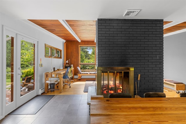 15 Relyea Ter, Wappingers Falls, NY 12590 - tiled living room featuring a fireplace, wooden ceiling, baseboard heating, french doors, and wood walls