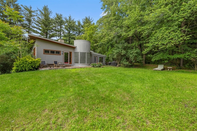 15 Relyea Ter, Wappingers Falls, NY 12590 - back of property featuring a lawn, a chimney, and a patio area