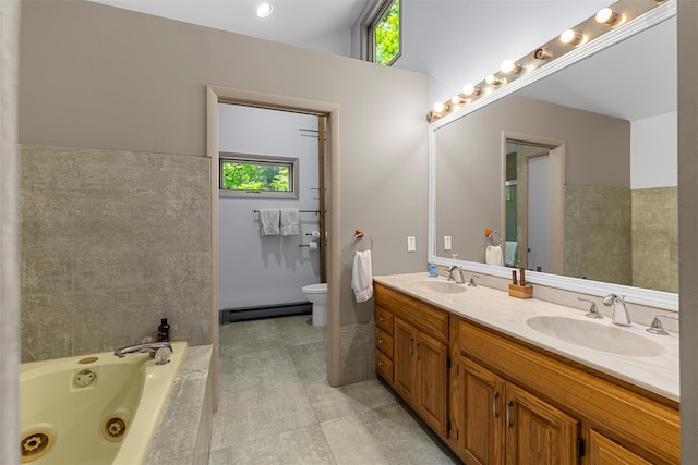 15 Relyea Ter, Wappingers Falls, NY 12590 - bathroom with a baseboard heating unit, double vanity, a whirlpool tub, and toilet