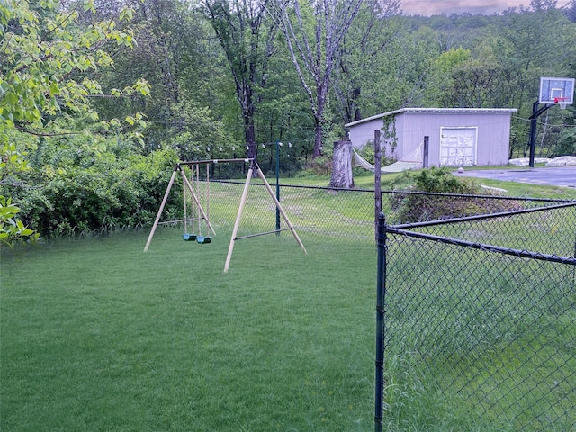 94 Highland Ave, Woodridge, NY 12789 - view of yard featuring asphalt driveway, a playground, a detached garage, and a wooded view