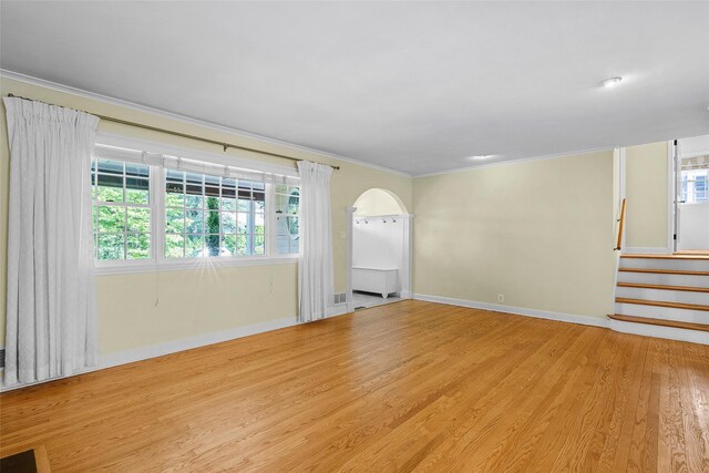 4 Senate Pl, Larchmont, NY 10538 - spare room featuring ornamental molding, arched walkways, light wood-type flooring, healthy amount of natural light, and stairway
