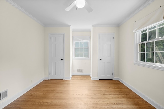4 Senate Pl, Larchmont, NY 10538 - unfurnished bedroom featuring ornamental molding, light wood finished floors, two closets, and ceiling fan