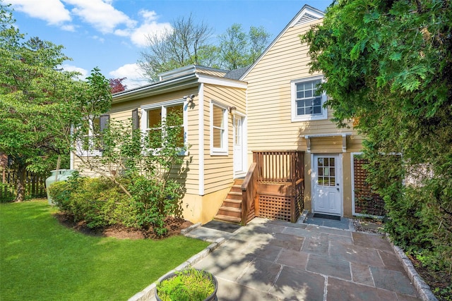 4 Senate Pl, Larchmont, NY 10538 - view of front facade featuring a front lawn and a patio