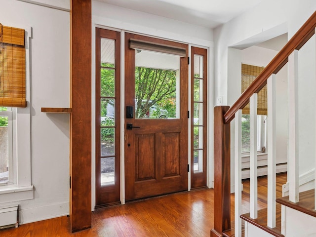 5221-5223 Rte 28, Mount Tremper, NY 12457 - entrance foyer featuring wood finished floors, plenty of natural light, a baseboard radiator, and stairway
