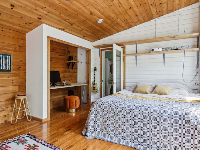 5221-5223 Rte 28, Mount Tremper, NY 12457 - bedroom with stacked washing machine and dryer, wood walls, vaulted ceiling, wooden ceiling, and wood finished floors