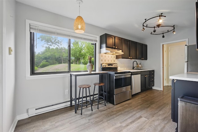 10 Millholland Dr Unit N, Fishkill, NY 12524 - kitchen with stainless steel appliances, under cabinet range hood, a sink, light countertops, and backsplash