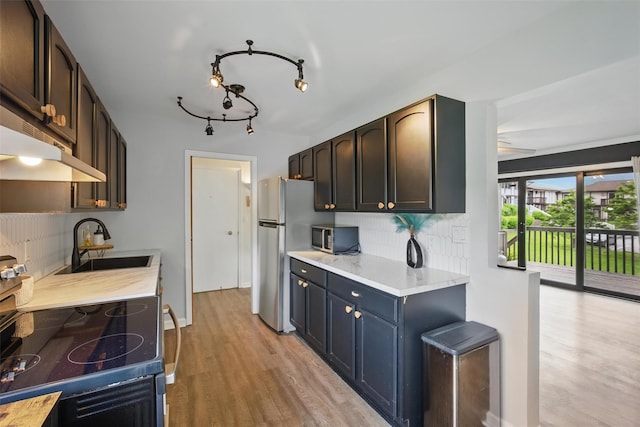 10 Millholland Dr Unit N, Fishkill, NY 12524 - kitchen with appliances with stainless steel finishes, a sink, tasteful backsplash, and light wood-style floors