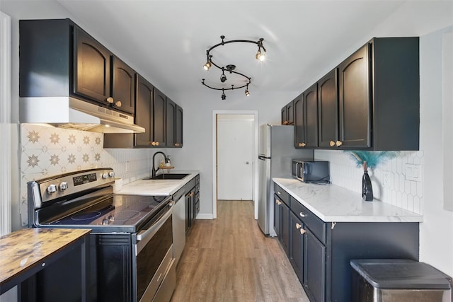 10 Millholland Dr Unit N, Fishkill, NY 12524 - kitchen featuring appliances with stainless steel finishes, a sink, light wood finished floors, and tasteful backsplash