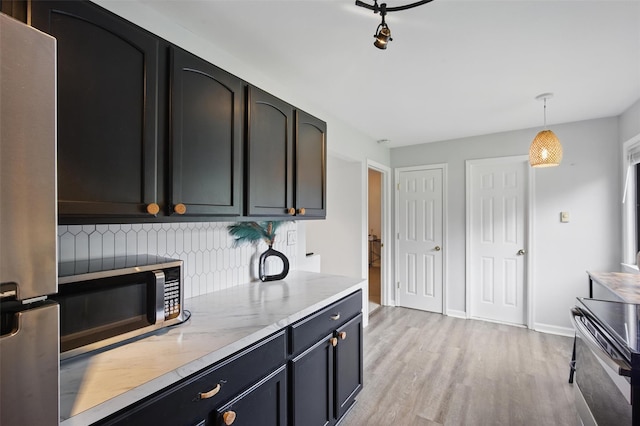 10 Millholland Dr Unit N, Fishkill, NY 12524 - kitchen featuring stainless steel appliances, light wood-style flooring, tasteful backsplash, pendant lighting, and baseboards