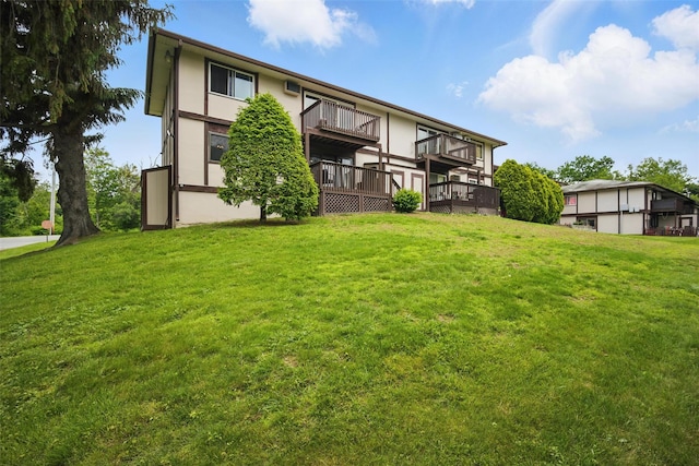 10 Millholland Dr Unit N, Fishkill, NY 12524 - back of house with a balcony, stucco siding, and a lawn