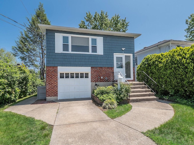 14 Marwood Rd S, Port Washington, NY 11050 - view of front of home with brick siding, concrete driveway, and a garage