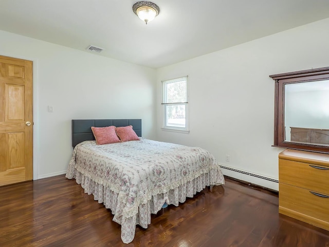 14 Marwood Rd S, Port Washington, NY 11050 - bedroom featuring a baseboard heating unit, dark wood-style flooring, and baseboards
