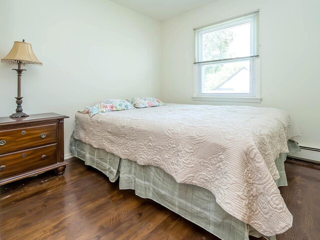 14 Marwood Rd S, Port Washington, NY 11050 - bedroom featuring dark wood finished floors and a baseboard radiator