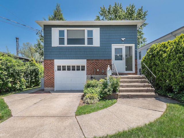14 Marwood Rd S, Port Washington, NY 11050 - view of front of home with brick siding, driveway, and an attached garage