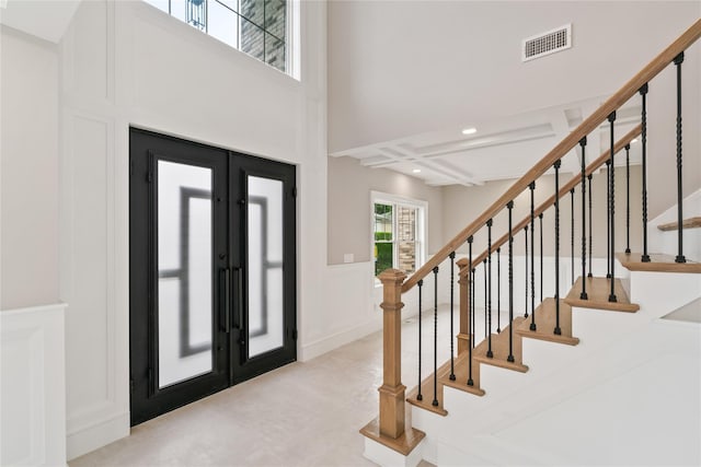 78 Shafter Ave, Albertson, NY 11507 - entrance foyer with a decorative wall, wainscoting, stairs, french doors, and beam ceiling