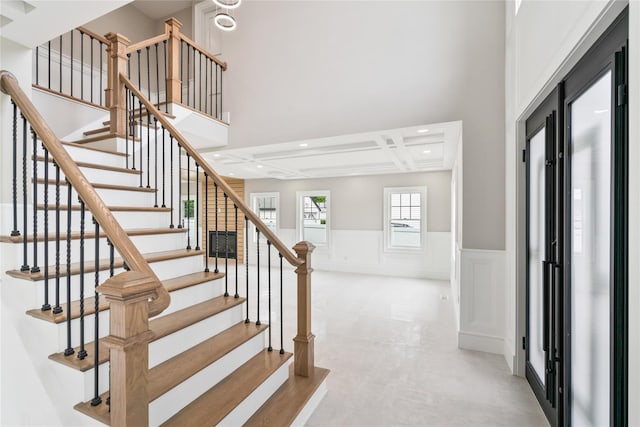 78 Shafter Ave, Albertson, NY 11507 - stairway with a wainscoted wall, a decorative wall, recessed lighting, and a towering ceiling