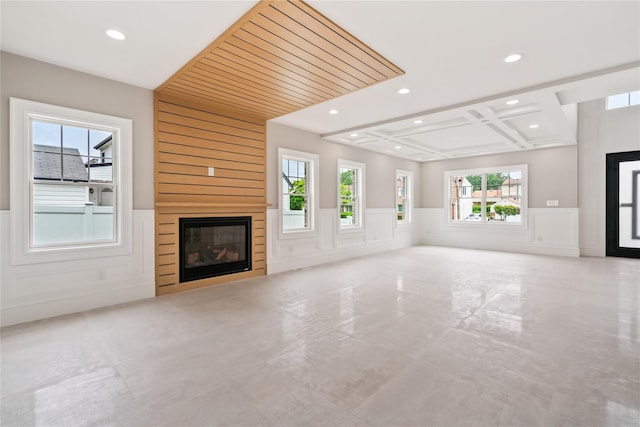 78 Shafter Ave, Albertson, NY 11507 - unfurnished living room with a decorative wall, a wainscoted wall, recessed lighting, a glass covered fireplace, and healthy amount of natural light