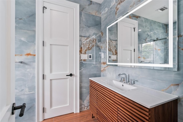 78 Shafter Ave, Albertson, NY 11507 - bathroom with tile walls, vanity, and wood finished floors