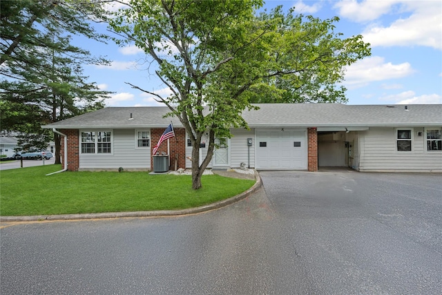 28 Trent Ct Unit B, Ridge, NY 11961 - ranch-style house with a garage, driveway, central air condition unit, and a front lawn