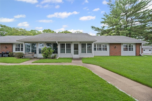 28 Trent Ct Unit B, Ridge, NY 11961 - ranch-style house with a front lawn, a sunroom, and brick siding