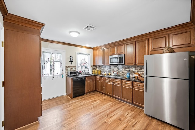 28 Trent Ct Unit B, Ridge, NY 11961 - kitchen featuring stainless steel appliances, dark countertops, brown cabinetry, ornamental molding, and tasteful backsplash