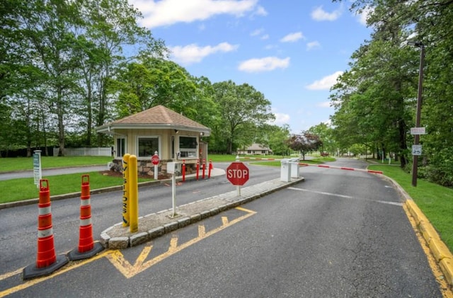28 Trent Ct Unit B, Ridge, NY 11961 - view of asphalt road featuring traffic signs, curbs, and street lighting