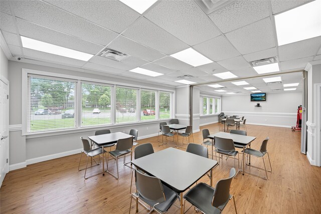 28 Trent Ct Unit B, Ridge, NY 11961 - dining space with light wood-style flooring, a paneled ceiling, and baseboards