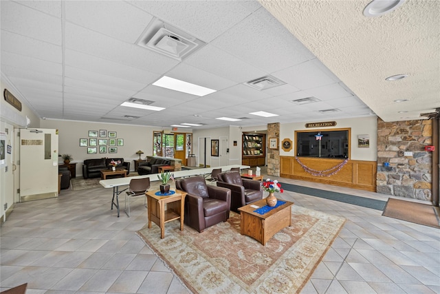 28 Trent Ct Unit B, Ridge, NY 11961 - living area with light tile patterned floors and a drop ceiling