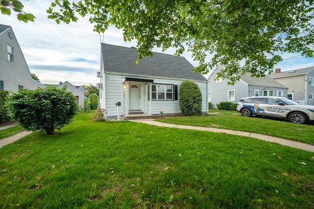 31 Peninsula Blvd, Valley Stream, NY 11581 - view of front of house featuring a front yard and roof with shingles