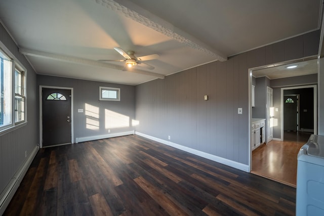 31 Peninsula Blvd, Valley Stream, NY 11581 - spare room featuring baseboard heating, washer / clothes dryer, dark wood finished floors, and a ceiling fan