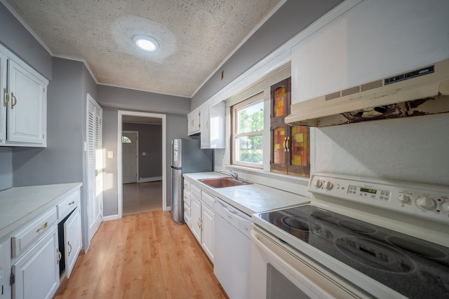 31 Peninsula Blvd, Valley Stream, NY 11581 - kitchen with white appliances, white cabinetry, light countertops, range hood, and ornamental molding