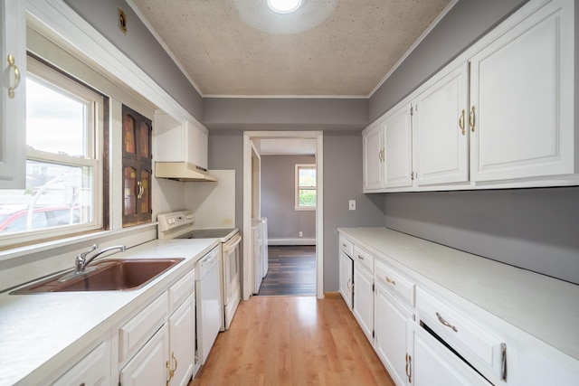 31 Peninsula Blvd, Valley Stream, NY 11581 - kitchen with white appliances, under cabinet range hood, white cabinets, light countertops, and crown molding