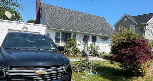 9 Clifton Dr, Patchogue, NY 11772 - view of front of home with a chimney and roof with shingles