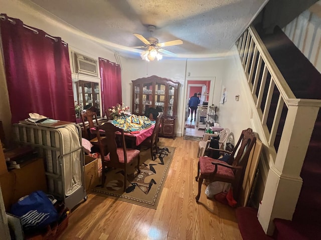 111-31 Lefferts Blvd, South Ozone Park, NY 11420 - dining room with stairway, wood finished floors, a ceiling fan, and a textured ceiling
