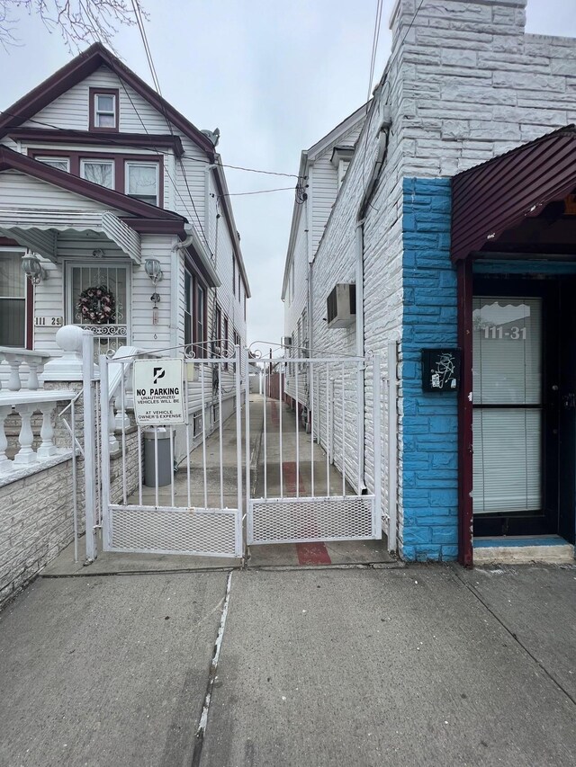 111-31 Lefferts Blvd, South Ozone Park, NY 11420 - view of side of property with a gate and stone siding