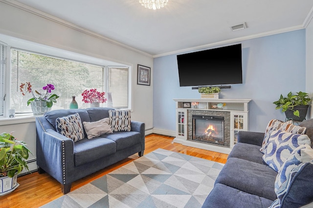 263 Claywood Dr, Brentwood, NY 11717 - living room featuring ornamental molding, wood finished floors, a stone fireplace, and baseboards