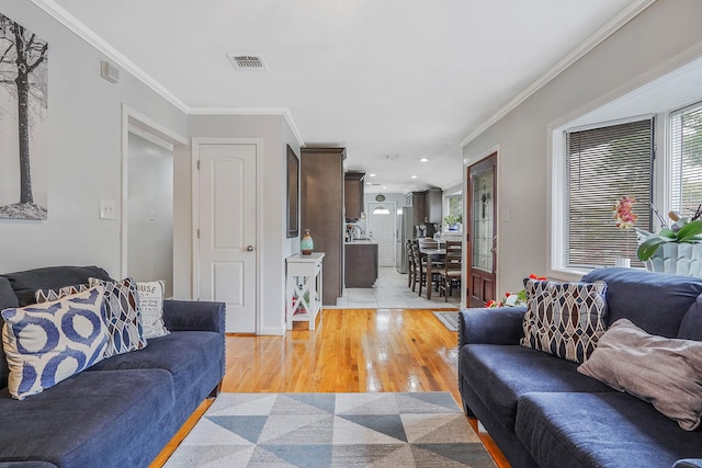 263 Claywood Dr, Brentwood, NY 11717 - living area with light wood finished floors, healthy amount of natural light, and ornamental molding
