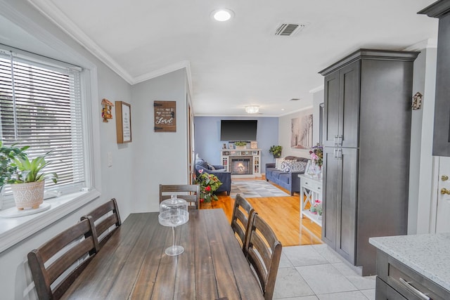 263 Claywood Dr, Brentwood, NY 11717 - dining room with ornamental molding, a glass covered fireplace, light tile patterned flooring, and recessed lighting