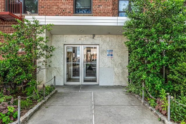 140-15 Holly Ave Unit 4E, Flushing, NY 11355 - doorway to property featuring french doors and brick siding