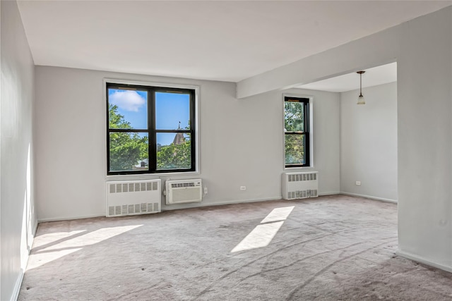 140-15 Holly Ave Unit 4E, Flushing, NY 11355 - unfurnished room featuring radiator heating unit, carpet floors, a wall mounted AC, and baseboards