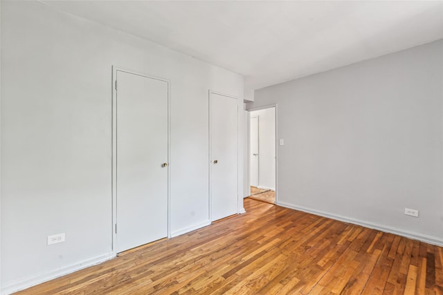 140-15 Holly Ave Unit 4E, Flushing, NY 11355 - unfurnished bedroom with light wood-style floors and baseboards