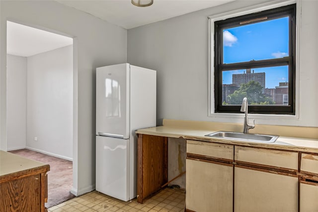 140-15 Holly Ave Unit 4E, Flushing, NY 11355 - kitchen featuring freestanding refrigerator, a sink, light countertops, and baseboards