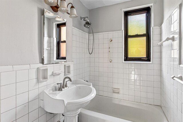 140-15 Holly Ave Unit 4E, Flushing, NY 11355 - bathroom with bathtub / shower combination, tile walls, a sink, and a wainscoted wall