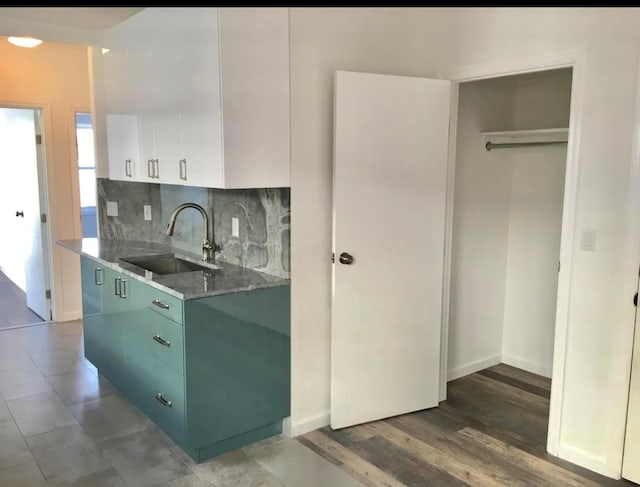75-09 60th Pl, Glendale, NY 11385 - kitchen featuring a sink, decorative backsplash, white cabinetry, green cabinets, and light countertops