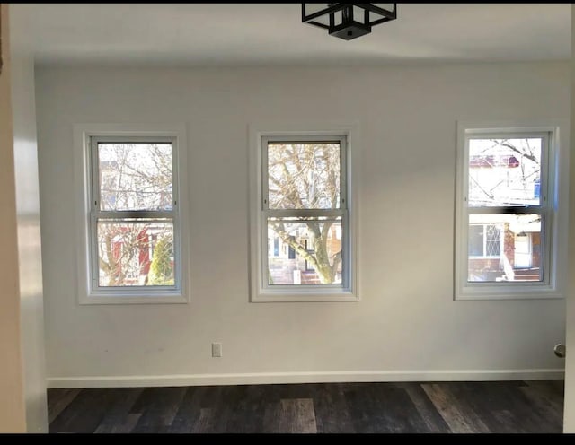 75-09 60th Pl, Glendale, NY 11385 - empty room featuring dark wood-style flooring and baseboards